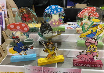 Collection of Handpainted Acrylic Standees on Display at Convention